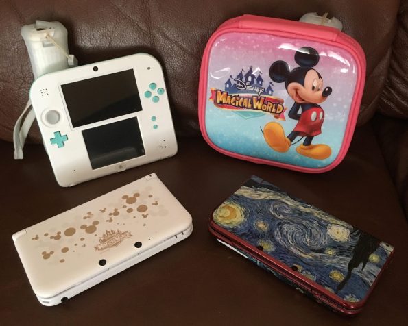 CJs 3Ds collection. LadiesGamers.com. 1 seafoam green 2DS, Disney Magical World 2DS case, 1 Disney Magical World 3DS, and 1 red new 3DS with Van Gogh Starry Night skin.