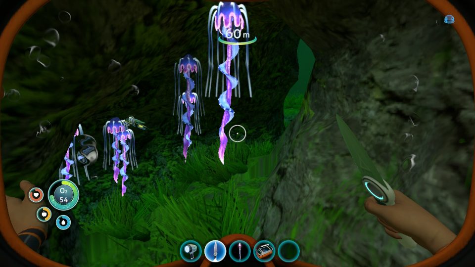 Subnautica. LadiesGamers.com.  Luminescent purple jellyfish at the entrance to a cave. It's otherwise dark.
