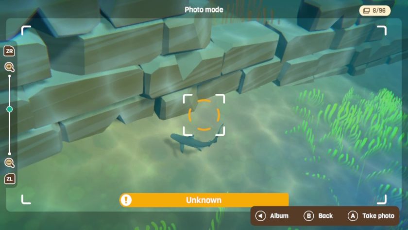 The photo mode with an orange exclamation as the subject is unknown. Zoom controls to the left side using ZL and ZR.