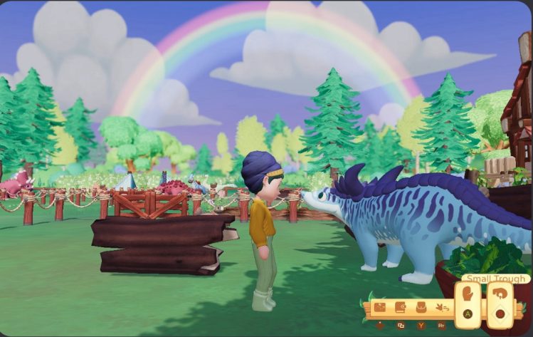 A character stands on a farm, face to face with a blue desmatosuchus. A rainbow arches across the sky. Trees, fencing, and other dinosaurs are behind the character and the dinosaur.