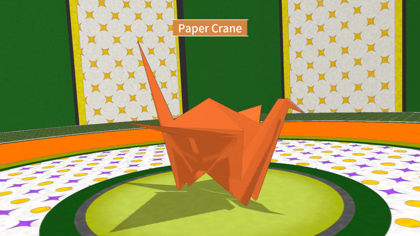 A paper crane sits in the middle of an orange and green table.