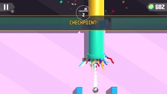 A vibrant 'Tricky Taps' checkpoint moment captured where a white ball passes through a checkpoint marked by a large green column with colorful ribbons attached, signifying progress in the game. Confetti explodes around the checkpoint area, adding to the celebratory atmosphere. The game interface shows a pause button in the upper left corner and a gem counter with a total of 682 gems on the upper right. The background is a soft pink, and the checkpoint is highlighted by a 'CHECKPOINT 2' label, indicating the player's achievement. Published on: LadiesGamers.