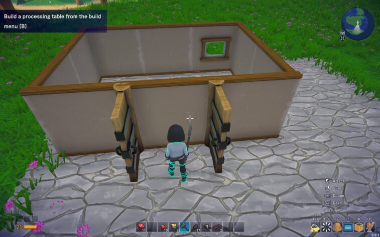 Omega Crafter in-game screenshot showing the player from behind, as they stand in front of a half-built wall with support beams, appearing to be in the process of constructing a processing table. An instruction overlay at the top suggests building a processing table from the build menu. The player's health and stamina bars are visible in the lower left corner, and the game's building and action hotbars are displayed at the bottom of the screen. The environment includes a cobbled ground and a grassy background with pink flowers, under a bright daylight setting. Published on: LadiesGamers.