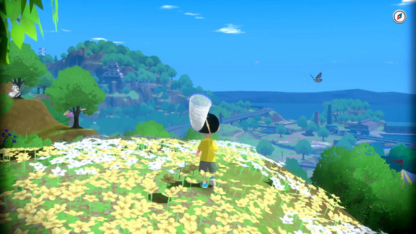 A child in a yellow shirt stands in a field of white and yellow flowers, holding a butterfly net. The scene overlooks a valley with lush greenery, distant hills, and a serene body of water under a clear blue sky. A butterfly flutters in the air, adding to the tranquil atmosphere. Published on: LadiesGamers.