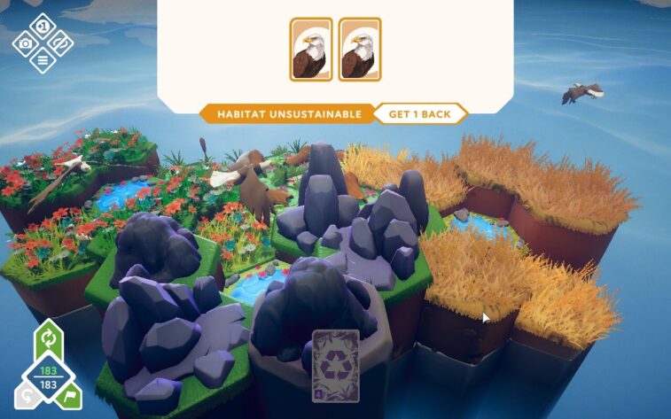 A floating island covered with hexagonal tiles showing a mix of lush green areas, rocky terrain, and dried grass. Two cards depicting eagles are displayed at the top, indicating an unsustainable habitat. Published on: LadiesGamers.