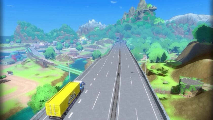 A scenic view of a highway stretches into the distance, surrounded by a vibrant landscape of forests, mountains, and small buildings, with a yellow truck driving along the road. Published on: LadiesGamers.