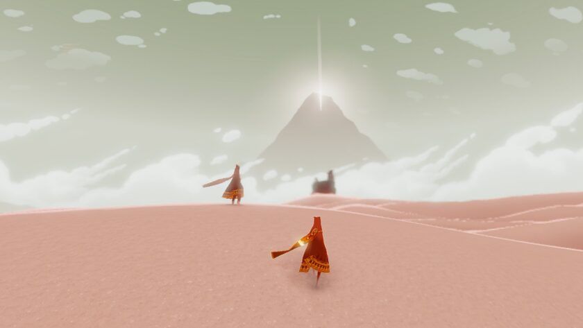 Two robed figures traverse a vast, sandy desert toward a glowing mountain in the distance. The sky is soft and cloudy, creating a dreamlike atmosphere in this serene and mysterious landscape. Published on: LadiesGamers.
