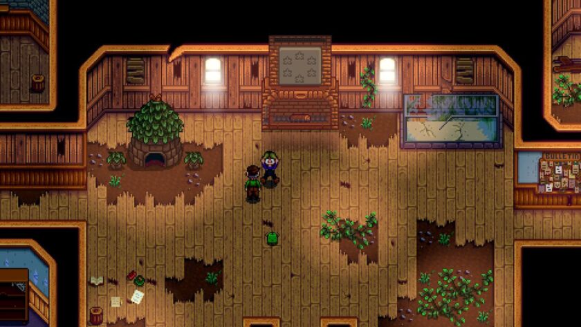 Inside the community centre, an abandoned building, with broken floorboards and foliage growing. My character is jumping with a shocked look and arms in the air, as there is a green creature with stick arms running across the floor behind Mayor Lewis. Published on: LadiesGamers