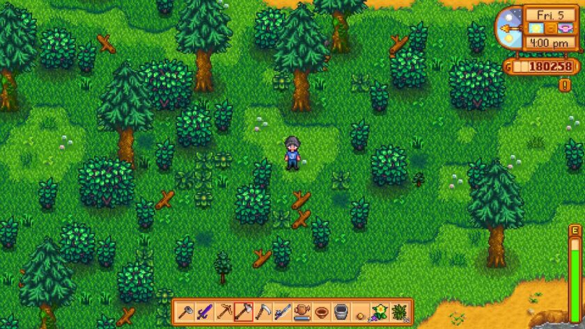 Pixelated character with blue trousers, blue hat and a blue Joja T-shirt standing in a forest. Published on LadiesGamers