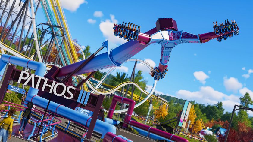 A vibrant amusement park scene from Planet Coaster 2, showcasing the thrilling "Pathos III" ride. The massive, futuristic pendulum ride swings high into the sky, with riders suspended at each end, arms and legs flailing in excitement. The queue area below is lined with blue and pink pathways marked "Standby" and "Priority," as park guests eagerly wait their turn. In the background, looping roller coasters twist and turn, adding to the excitement of the park. The setting is bright and colorful, with lush greenery and a clear blue sky enhancing the lively atmosphere. Published on: LadiesGamers.