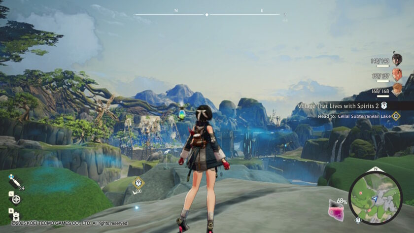 Yumia stands on a cliffside overlooking a vast fantasy landscape with waterfalls, rocky formations, and a distant village. The UI shows a quest objective, a mini-map, and party HP bars. Published on: LadiesGamers.