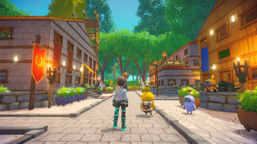 A 3D-rendered scene showing a futuristic character walking down a stone path in a peaceful village, accompanied by two small robot-like creatures. The village features wooden and stone buildings, colorful flags, and lush greenery, all set against a backdrop of tall, vivid trees under a bright blue sky. Published on: LadiesGamers.