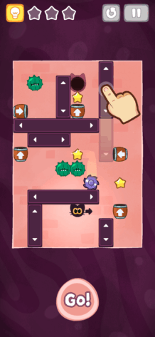 A vertical puzzle screen with a cute black cat character navigating through a maze of sliding blocks, spike traps, and collectible stars. Arrows and a hand gesture guide players on how to move elements in the level. The interface includes a lightbulb hint icon, a pause button, and a big “Go!” button. Published on: LadiesGamers