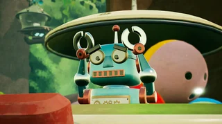 A blue and red cartoon-style robot with a rectangular mouth and expressive eyes holds its claw hands to its head in a worried pose. The robot stands in front of a colorful, whimsical background featuring a large mushroom cap-like structure and oversized round objects. The playful, vibrant aesthetic suggests a lighthearted tone. From Misc. A Tiny Tale. Published on: LadiesGamers.