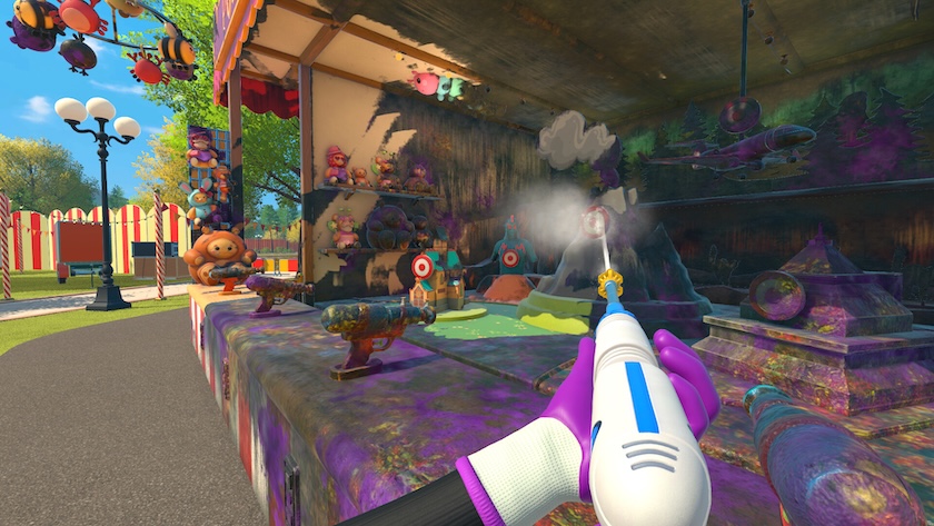Purple gloves hold a powerwasher, cleaning an arcade game