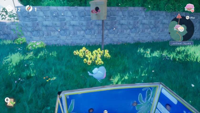 A birdhouse with flowers under it in Garden Trills.