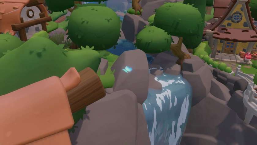A little blue butterfly flying over a waterfall, with a yellow stone house in the background. Published on LadiesGamers