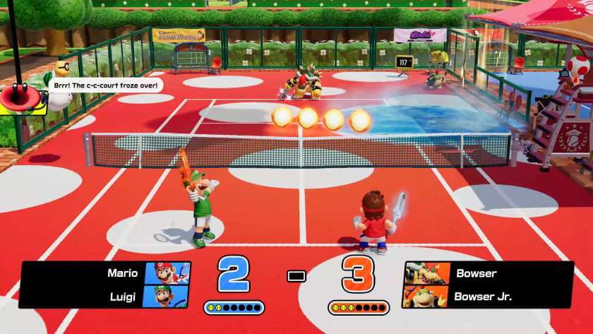 A red floored court with white circles, representing a mushroom. Luigi and Mario are playing against Bowser and Bowser Jr. Published on LadiesGamers