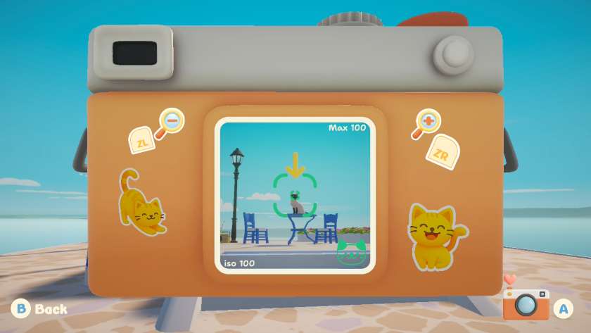 Camera taking up most of the screen with the image focused on a cat sitting on a table, with an arrow above it. Published on LadiesGamers