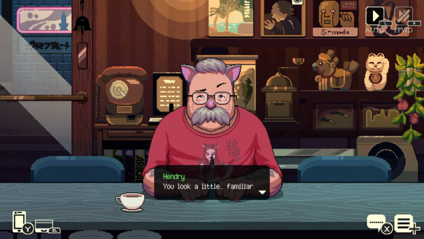 a man with glasses and red shirt sitting in a cafe