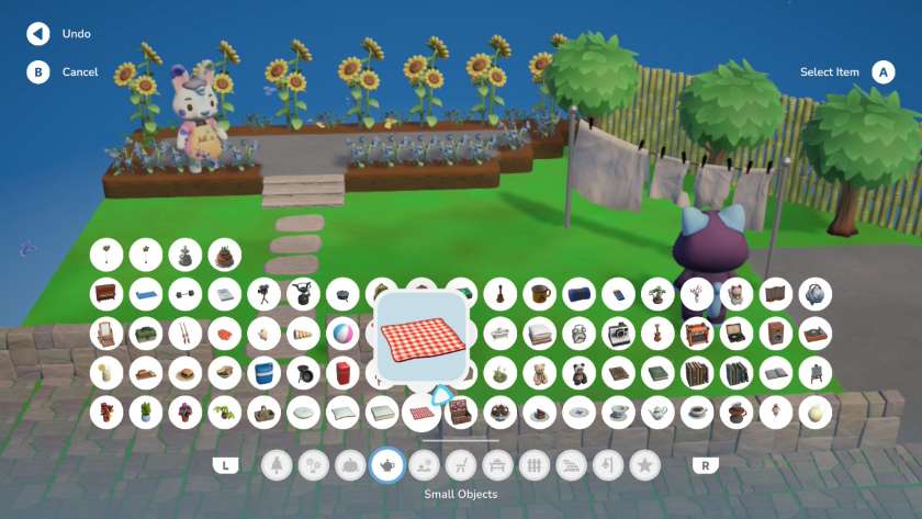 The small objects tab in the decoration menu, with lots of different items to choose from including books, food, plants and musical instruments. Published on LadiesGamers
